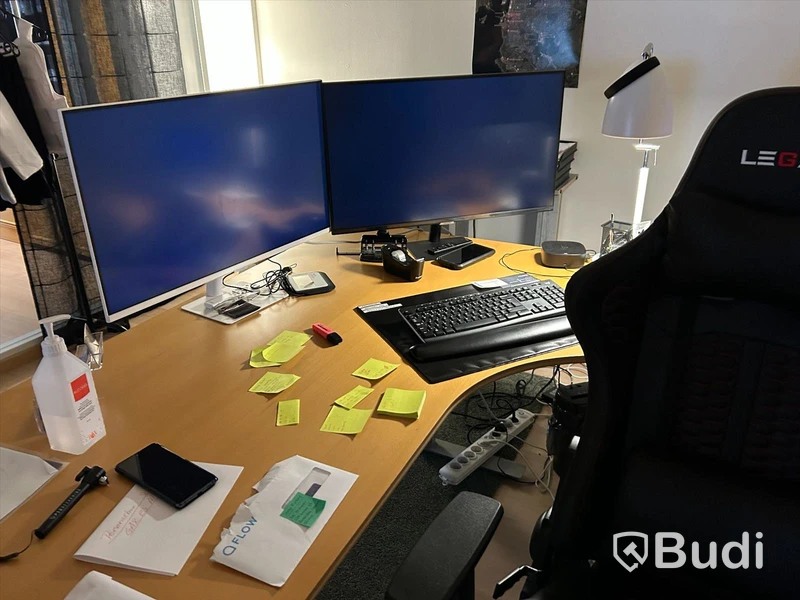 Kontorsrum med skrivbord, stol, besöksstolar, förvaring, två Samsung dataskärmar, skrivare. OBS! dator ingår ej
