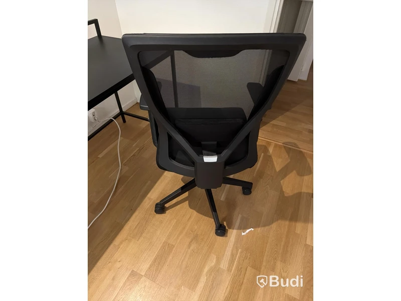 Black desk with office chair and lamp