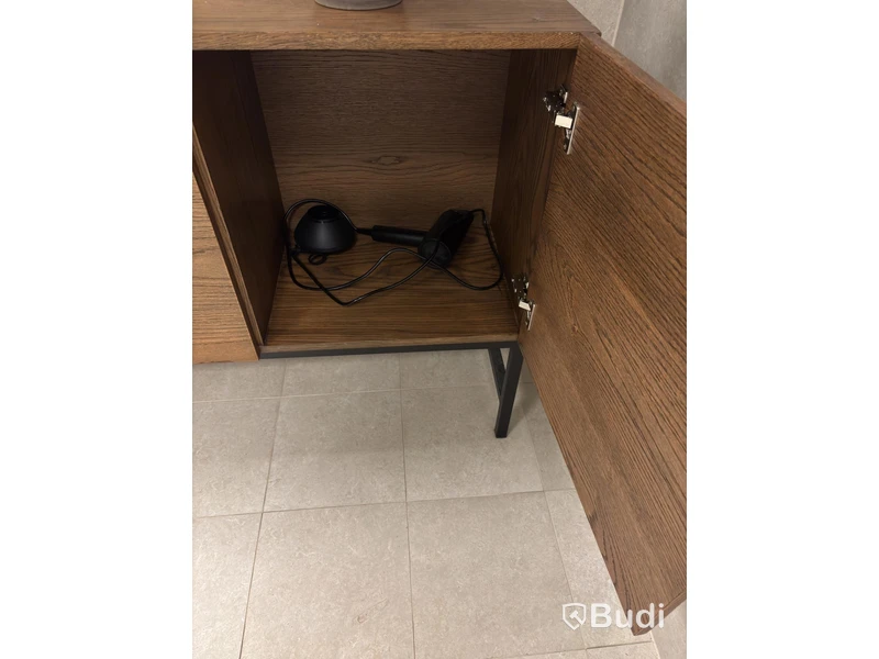 Cabinet including mirror and artificial plant