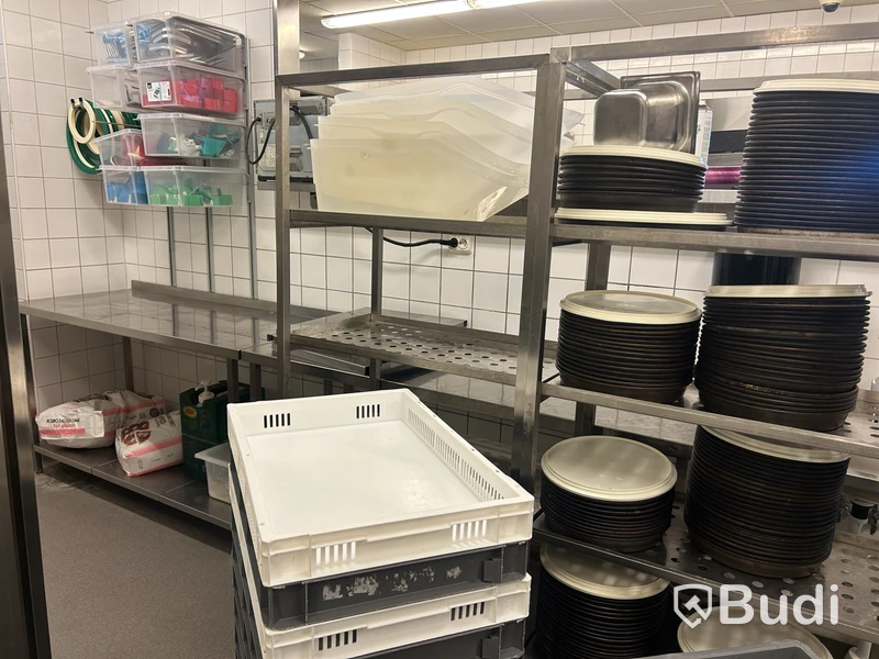 3 stainless steel shelving units with contents and bins