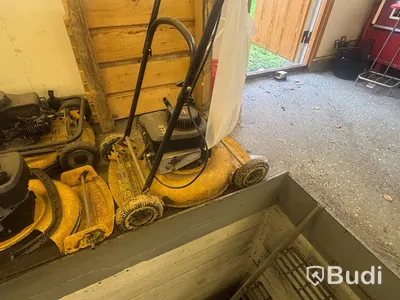 Four petrol-powered lawn mowers. Sold as repair items.