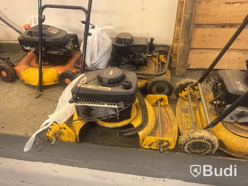 Four petrol-powered lawn mowers. Sold as repair items.