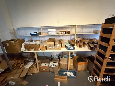 Arbetsbänkar med tillhörande hyllplan. Parti med förpackningsmaterial och kartonger.