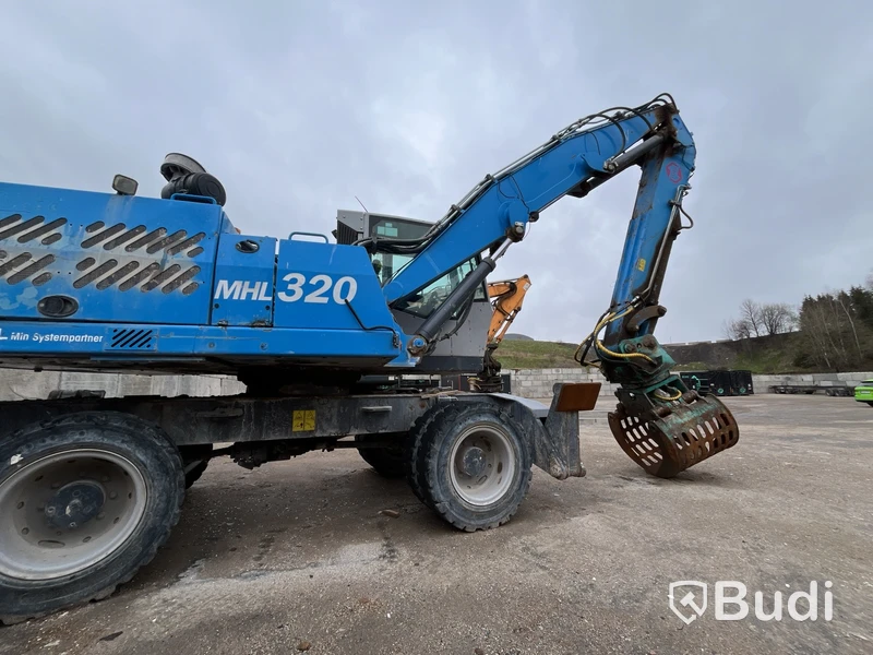 Materialhanterare med Grip Fuchs MHL 320 -2015  | Höj- och sänkbar hytt