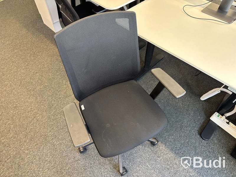 Höj- och sänkbart skrivbord med kontorsstol och datorskärm