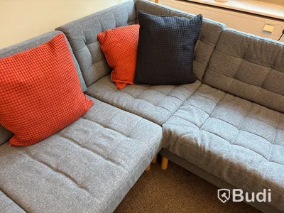 Loungegrupp med soffa, soffbord, pallar, tavellister, tavlor, växt