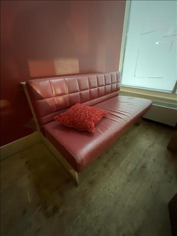 Platsbyggd soffa med röda dynor 