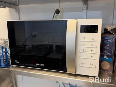 3 stainless steel shelves and a Samsung microwave oven