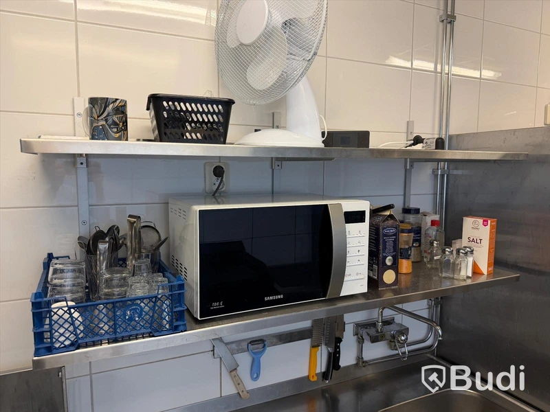 3 stainless steel shelves and a Samsung microwave oven