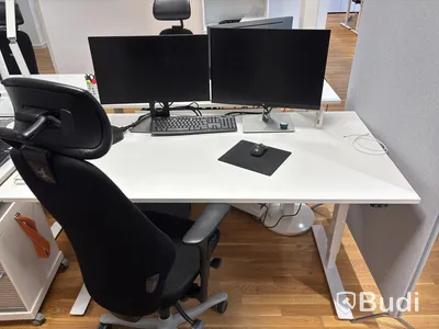 Office workstation with height-adjustable desk, Kinnarps chair, 2 Dell monitors, screen divider