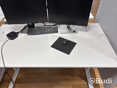 Office workstation with height-adjustable desk, Kinnarps chair, 2 Dell monitors, screen divider