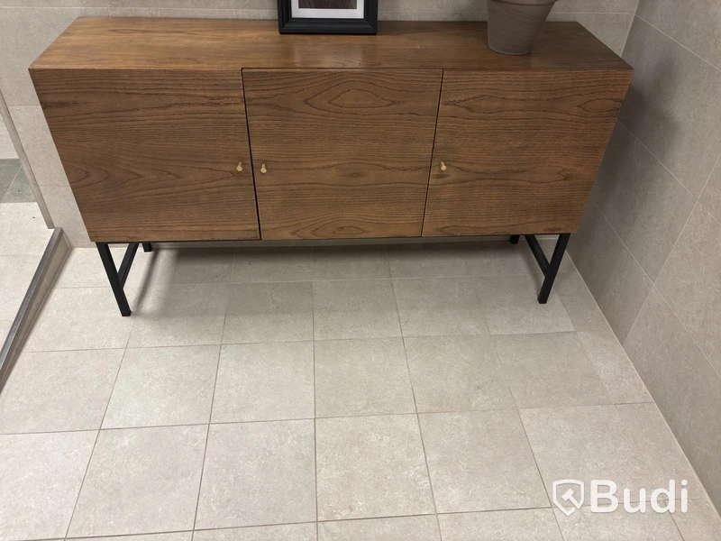 Cabinet including mirror and artificial plant