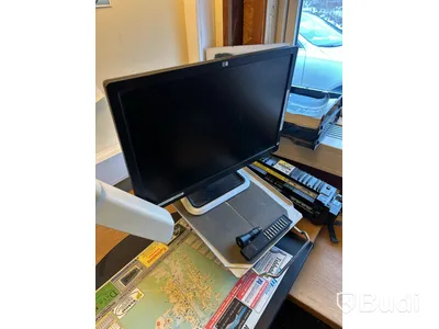 Skrivbord med HP-datorskärm och arbetslampa