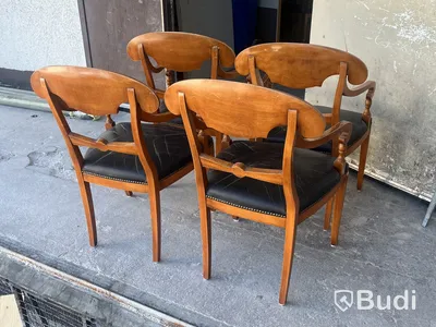 4 Selva armchairs, wood with black leather seats and nailhead trim