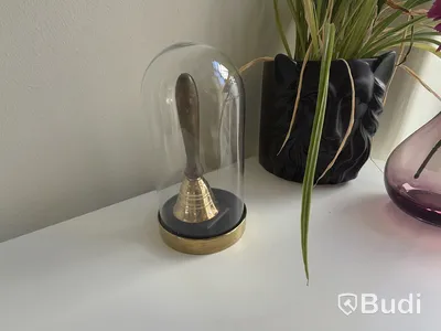 Bordsklocka i glasmonter samt prydnadsväxter