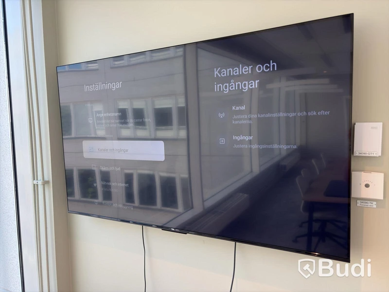 TCL 65-inch TV with remote control and wall mount