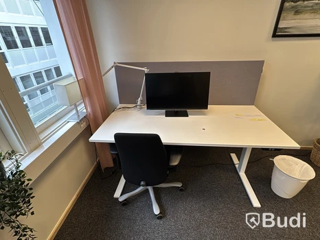 Höj- och sänkbart skrivbord med kontorsstol och Samsung-skärm