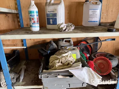 Metal shelving units with contents, ladders, etc.