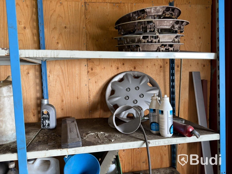 Metal shelving units with contents, ladders, etc.