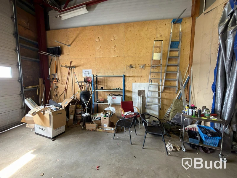 Metal shelving units with contents, ladders, etc.