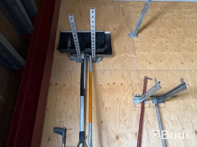 Metal shelving units with contents, ladders, etc.