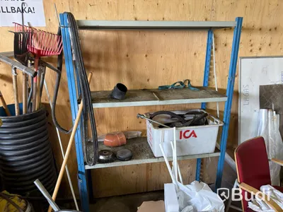 Metal shelving units with contents, ladders, etc.