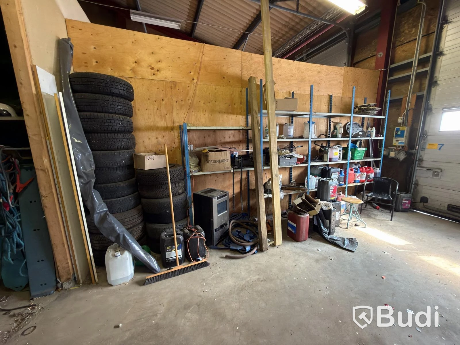 Metal shelving units with contents, ladders, etc.