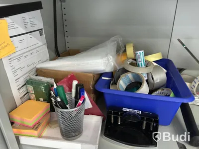 Grey metal storage cabinet with shelves and contents.