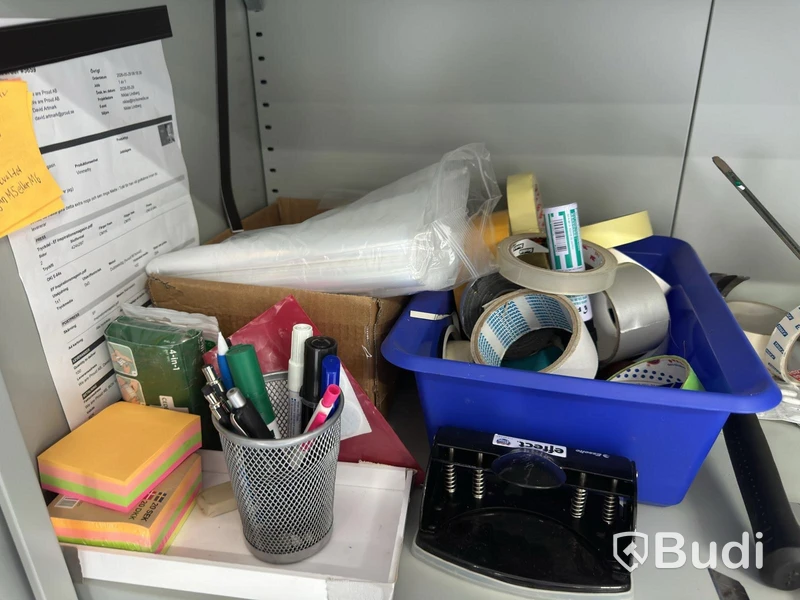 Grey metal storage cabinet with shelves and contents.