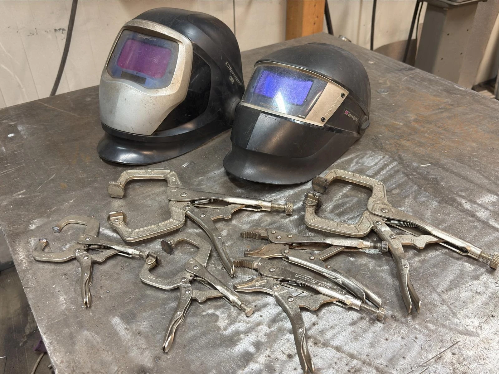 2 3M welding helmets and 6 welding clamps