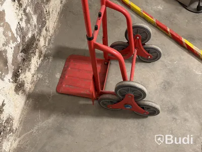 Stair-climbing hand truck, red-painted metal