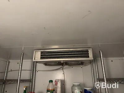 Walk-in cooler with refrigeration unit and shelving