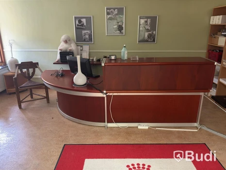 Skrivbord i receptionsutförande samt munkstol och bokhyllor