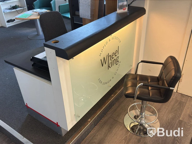 Receptionsdisk med skrivbord samt dokumentskåp och bord med 3 fåtöljer