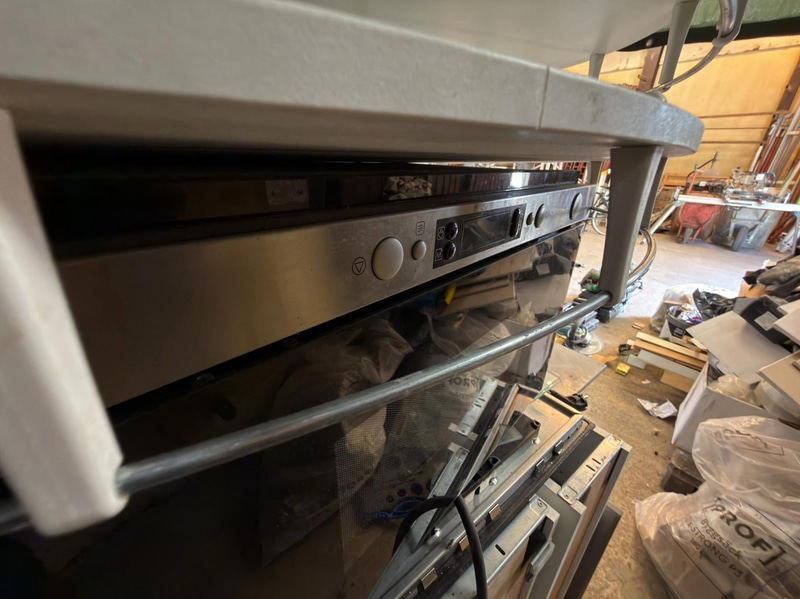 Kitchen with oven, hob, extractor fan, etc.
