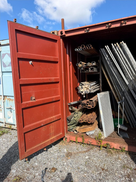 20-foot container with assorted materials (surplus materials and temporary cold-room doors)