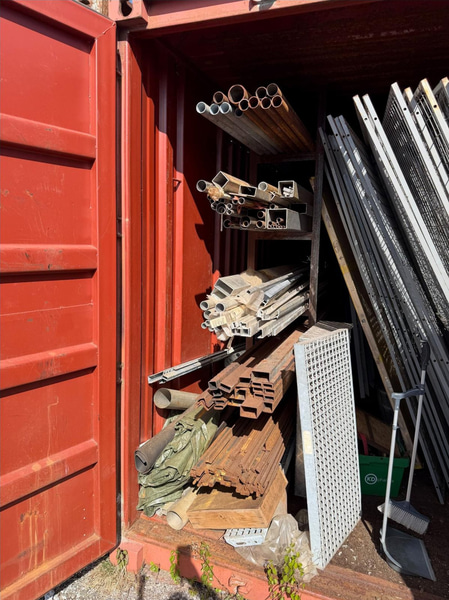 20-foot container with assorted materials (surplus materials and temporary cold-room doors)