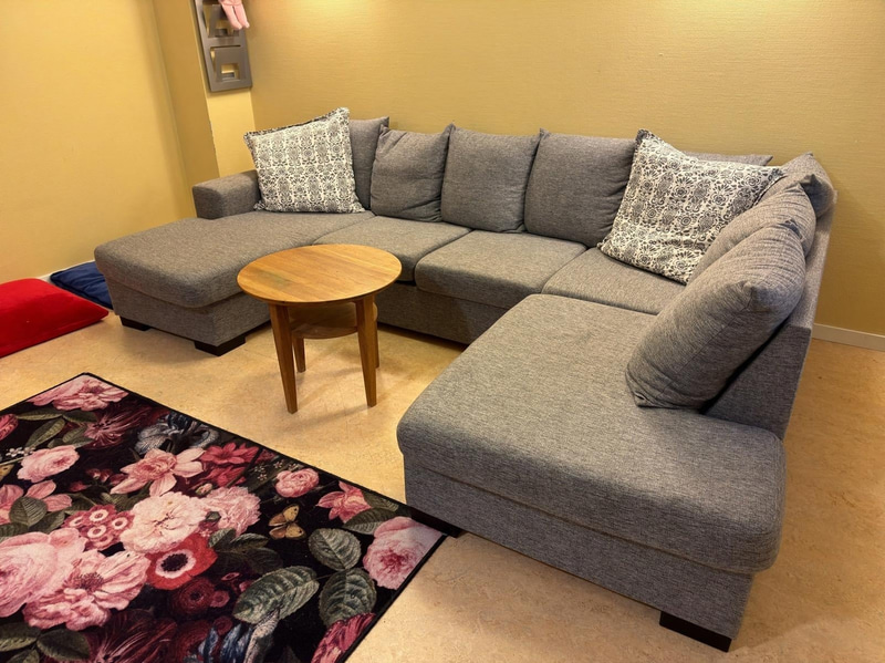 Sofa with chaise sections, coffee table and armchair