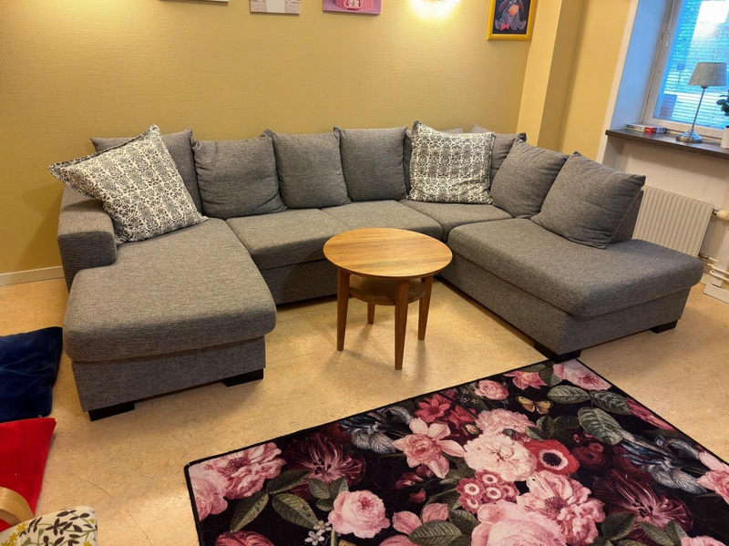 Sofa with chaise sections, coffee table and armchair