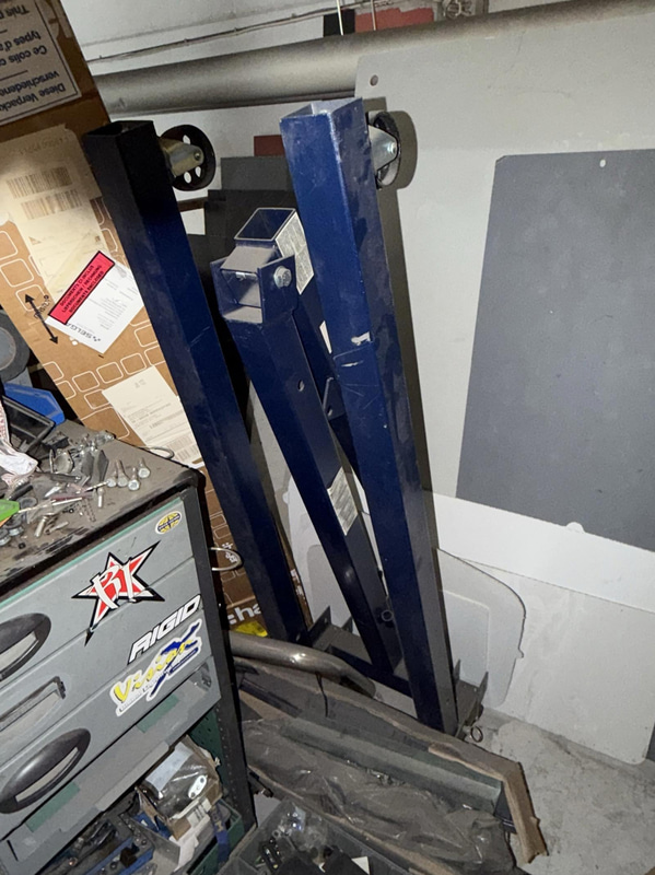 2 tool trolleys with tools and an engine hoist