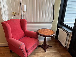 Fåtölj, sidobord och lampa